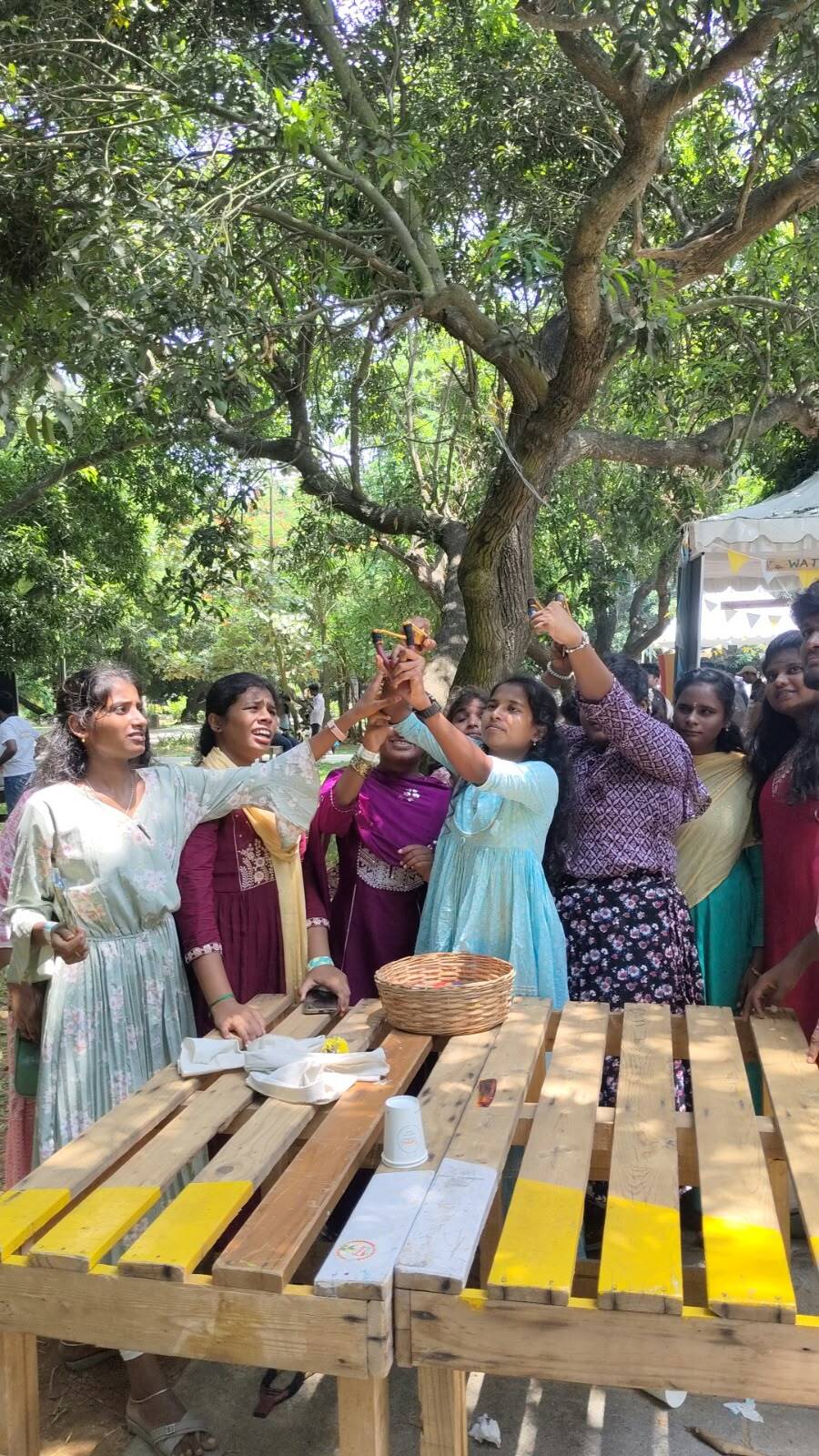 Students of Thaaikarangal Charitable Trust participating in a mango-tasting activity at Hanu Reddy Mango Festival 2026, exploring mangoes through touch, taste and sensory experiences in the natural farm setting at Hanu Reddy Raghava Farms, Chennai. Students of Thaaikarangal Charitable Trust participating in a mango-tasting activity at Hanu Reddy Mango Festival 2026, exploring mangoes through touch, taste and sensory experiences in the natural farm setting at Hanu Reddy Raghava Farms, Chennai.