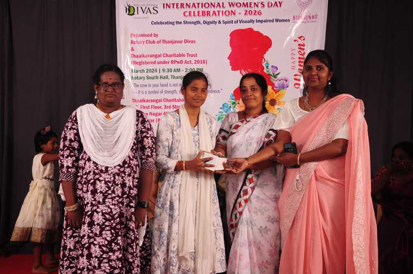 Visually impaired student receiving a gift from organisers on stage during the International Women’s Day Celebration 2026 in Thanjavur Visually impaired student receiving a gift from organisers on stage during the International Women’s Day Celebration 2026 in Thanjavur