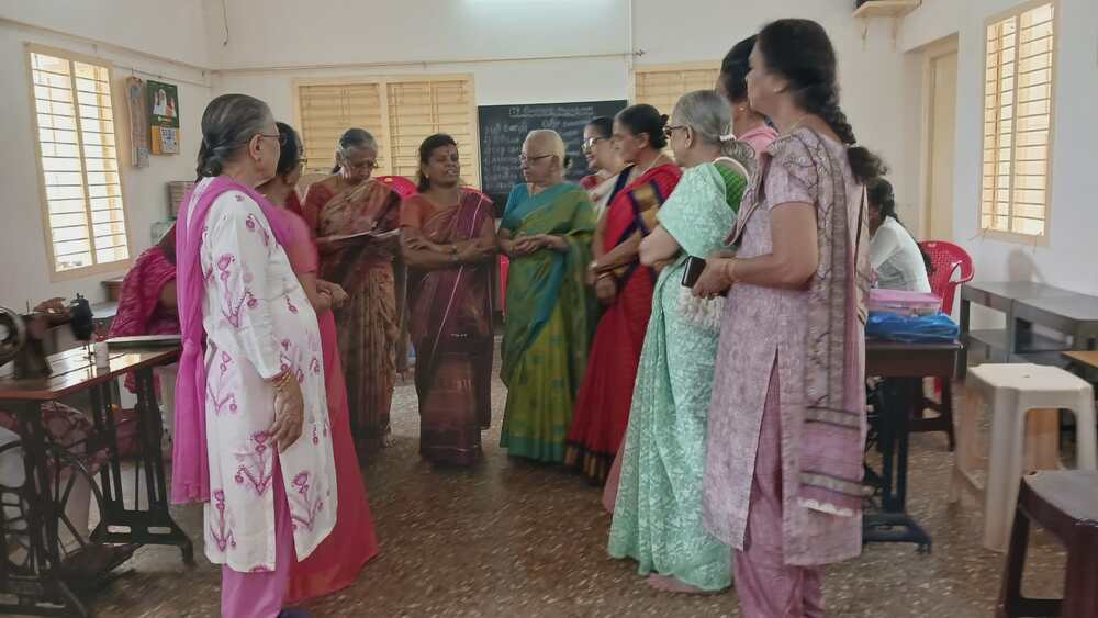 Participants, volunteers, and supporters interact during the residential sewing training camp, highlighting the community spirit behind empowering visually impaired women through tailoring skills. Participants, volunteers, and supporters interact during the residential sewing training camp, highlighting the community spirit behind empowering visually impaired women through tailoring skills.